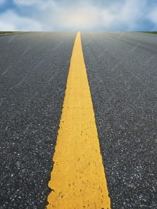 Black road with yellow line down the middle