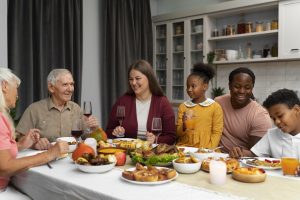 Three generations of a family that are multiracial are having dinner together.