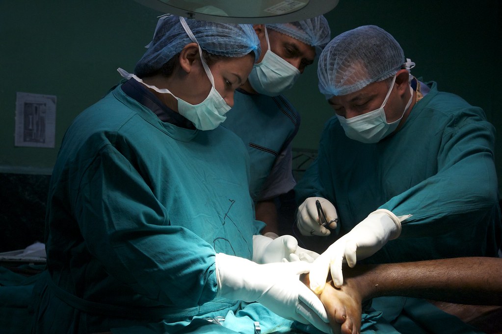 Three surgeons performing a surgery