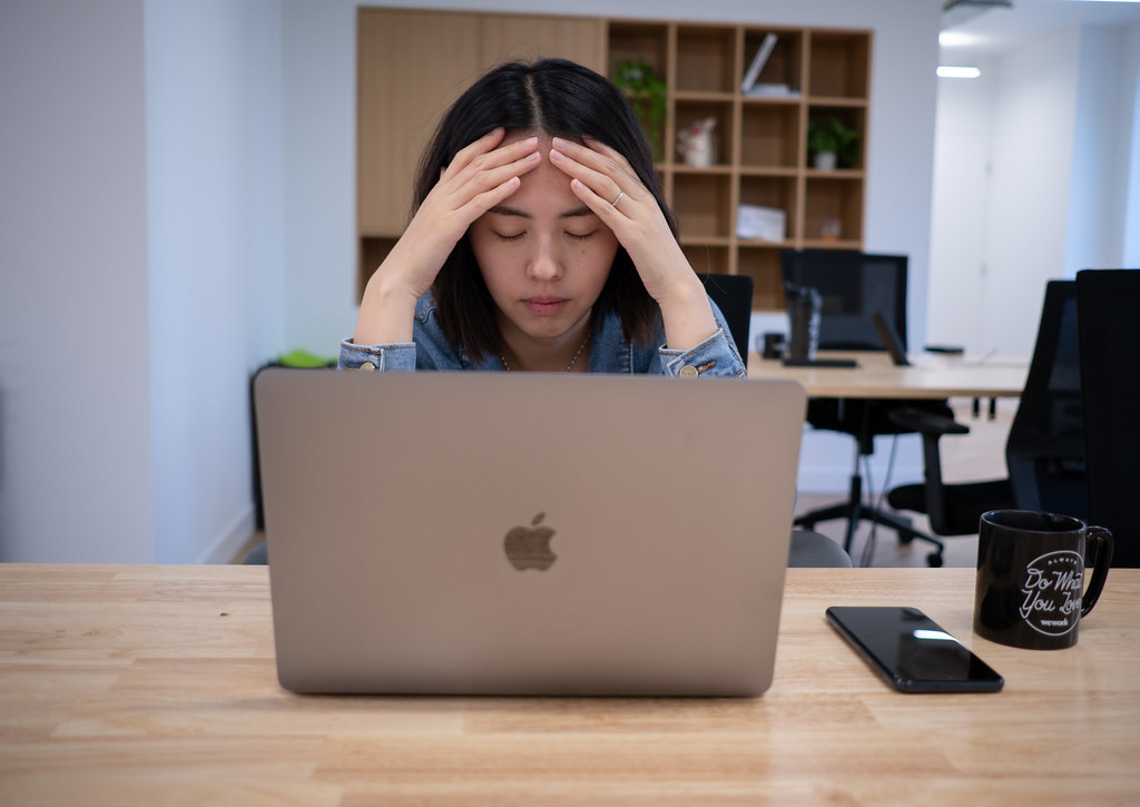 Tired office worker sitting in front of the computer