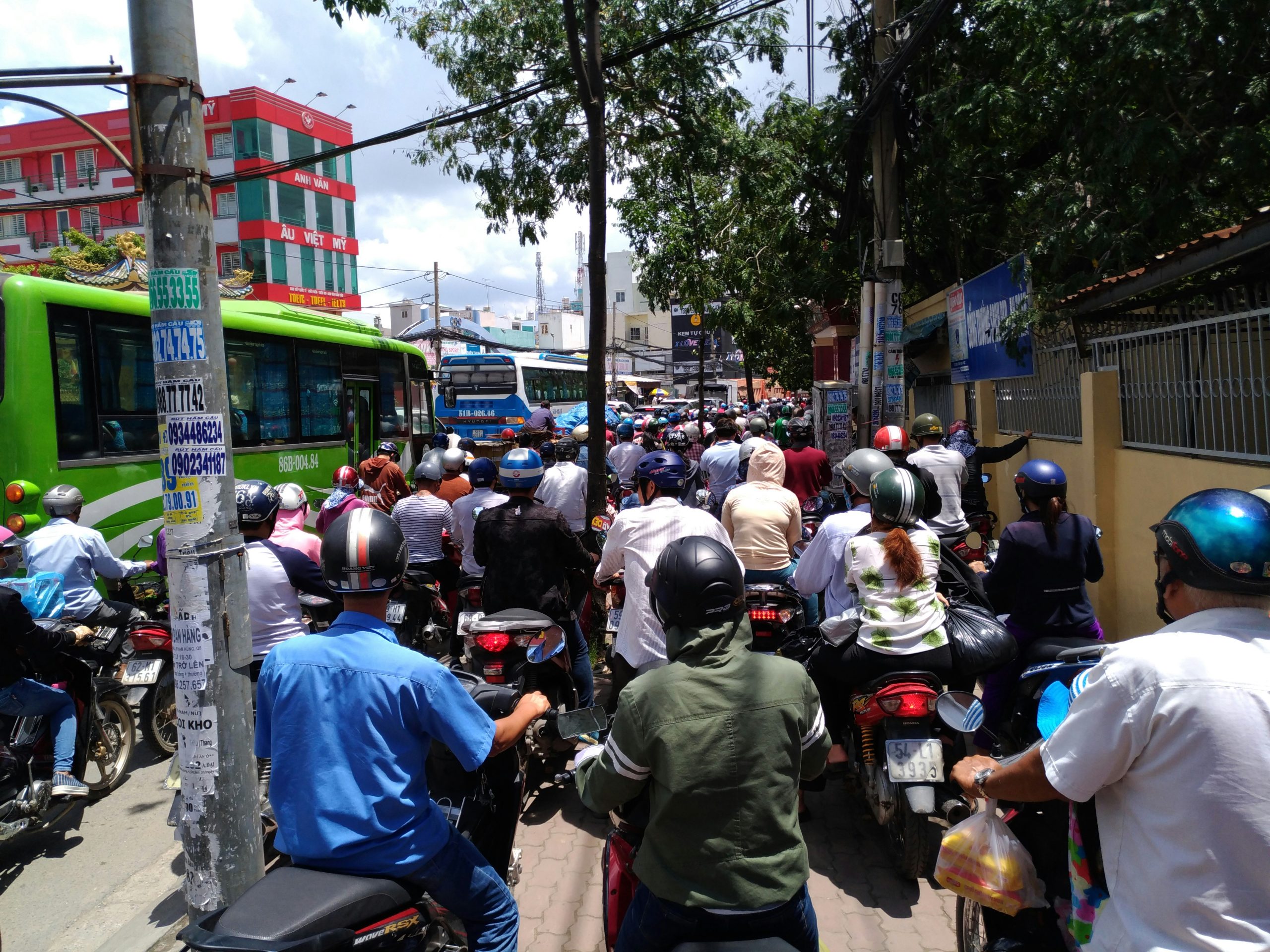 Traffic jams in city, with people driving motorbikes on the pavement