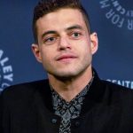 short haired white man (Rami Malek) in a suit