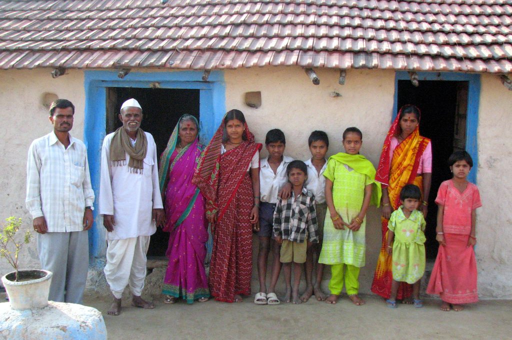 A rural Indian family in front of their home