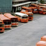 A bus station where several buses are parked