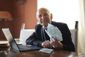 old man holding money