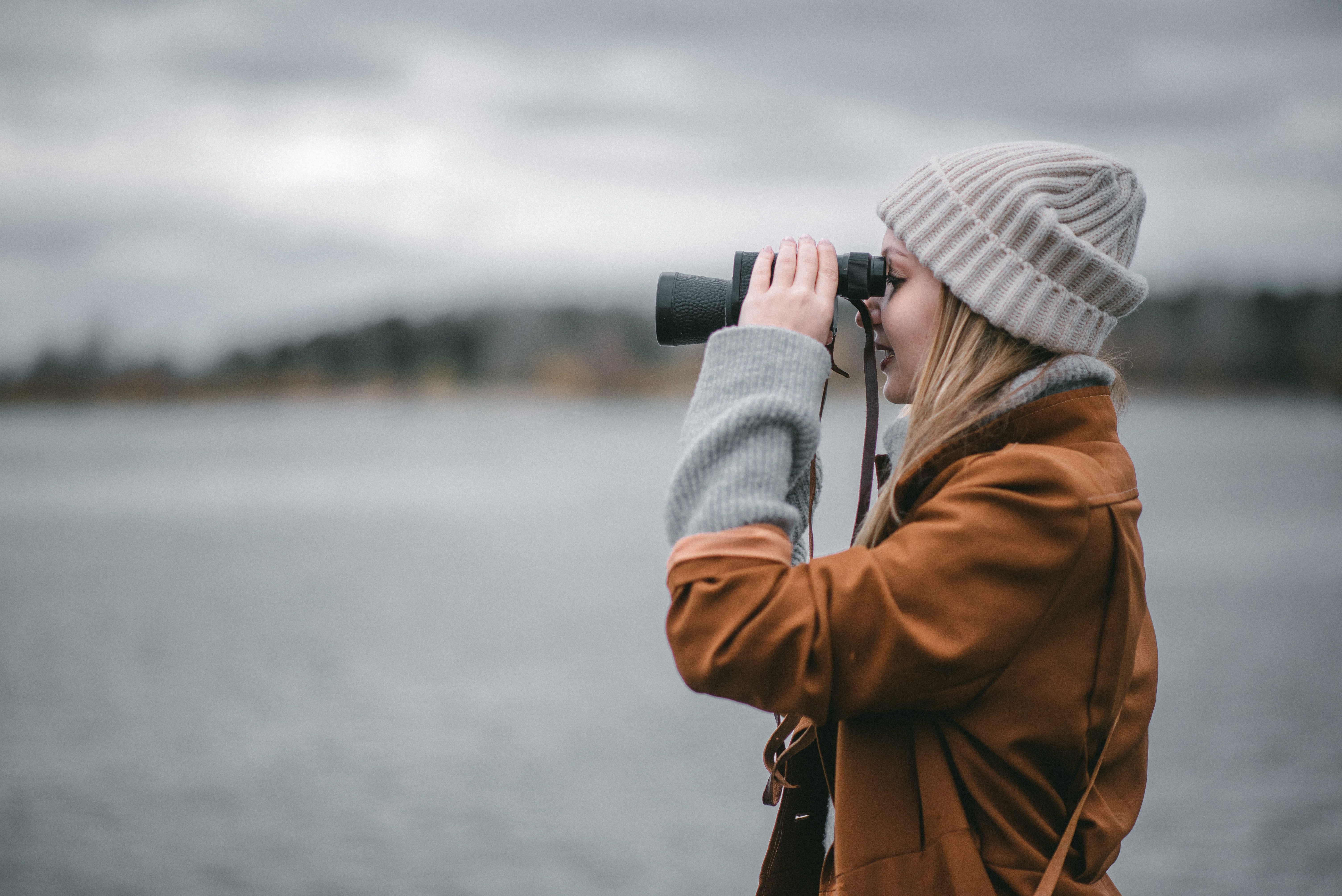 person looking through binoculars outdoors