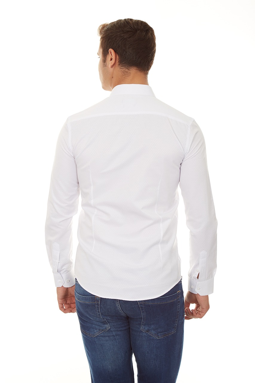 A man is depicted from behind, wearing jeans and a white shirt. Although the shirt fits him well, the jeans are a bit tight.