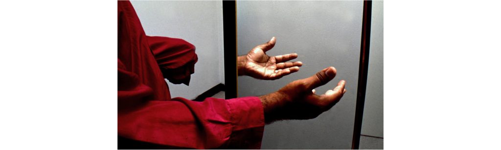 Image of an amputee using a mirror box. Mirror box therapy is used to treat individuals that experience phantom limb pain. Details in caption and text.
