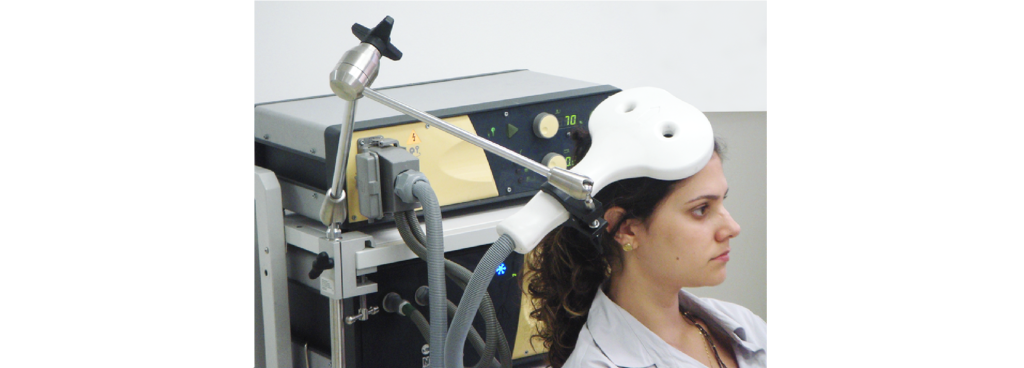 Picture showing someone undergoing transcranial magnetic stimulation therapy. Details in caption and text.