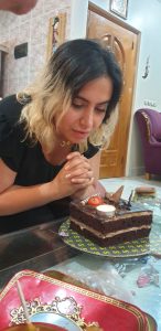 Image of Young iranian girl looking at her birthday cake adn reavy