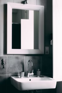 image of white sink with black tiles in the bathroom