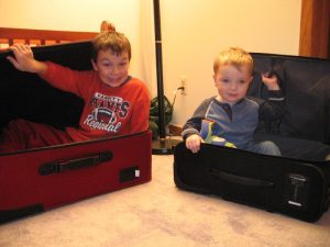 2 kids inside 2 luggage.