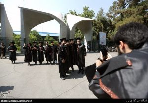 a few student taking picture in front of the Tehran university