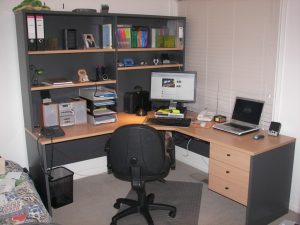 home office -corner desk and book shelf with a notebook PC and a desktop PC.